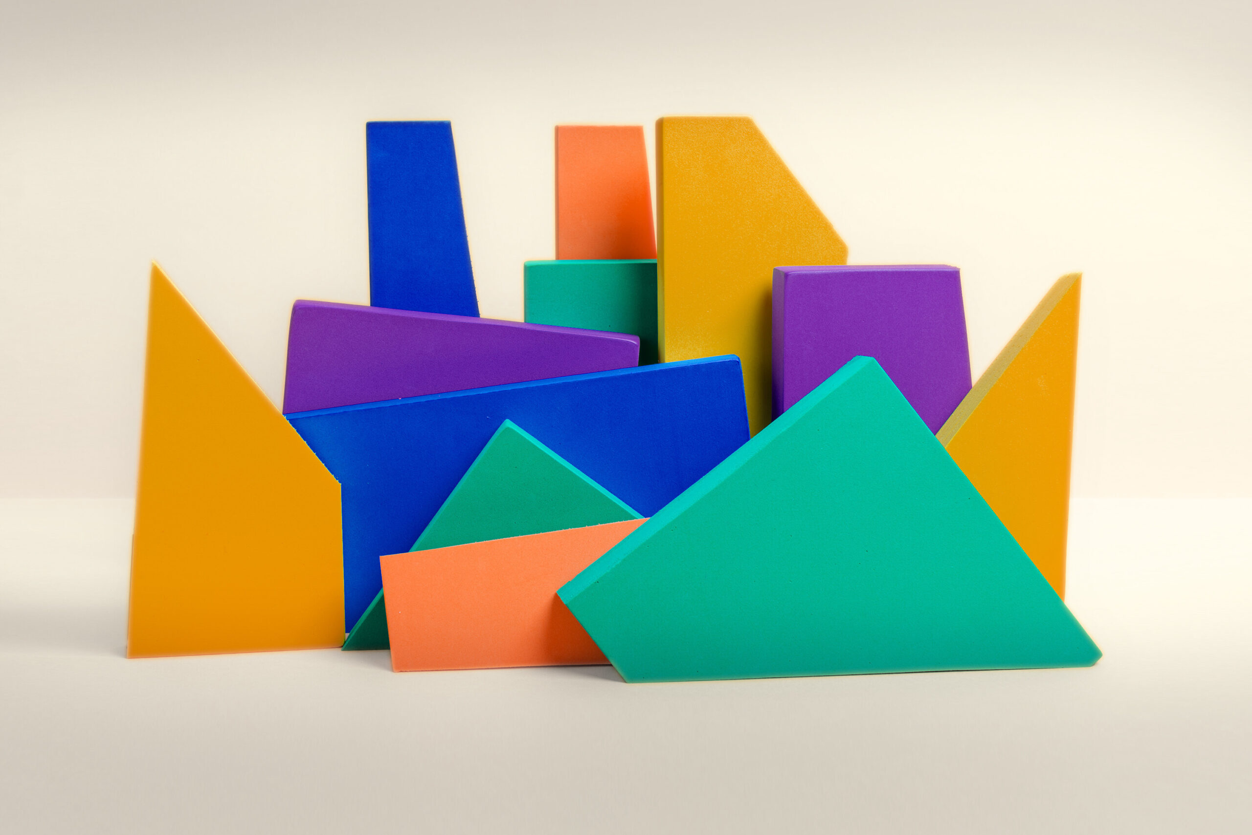 Stack of wooden blocks in multiple shapes and colors.